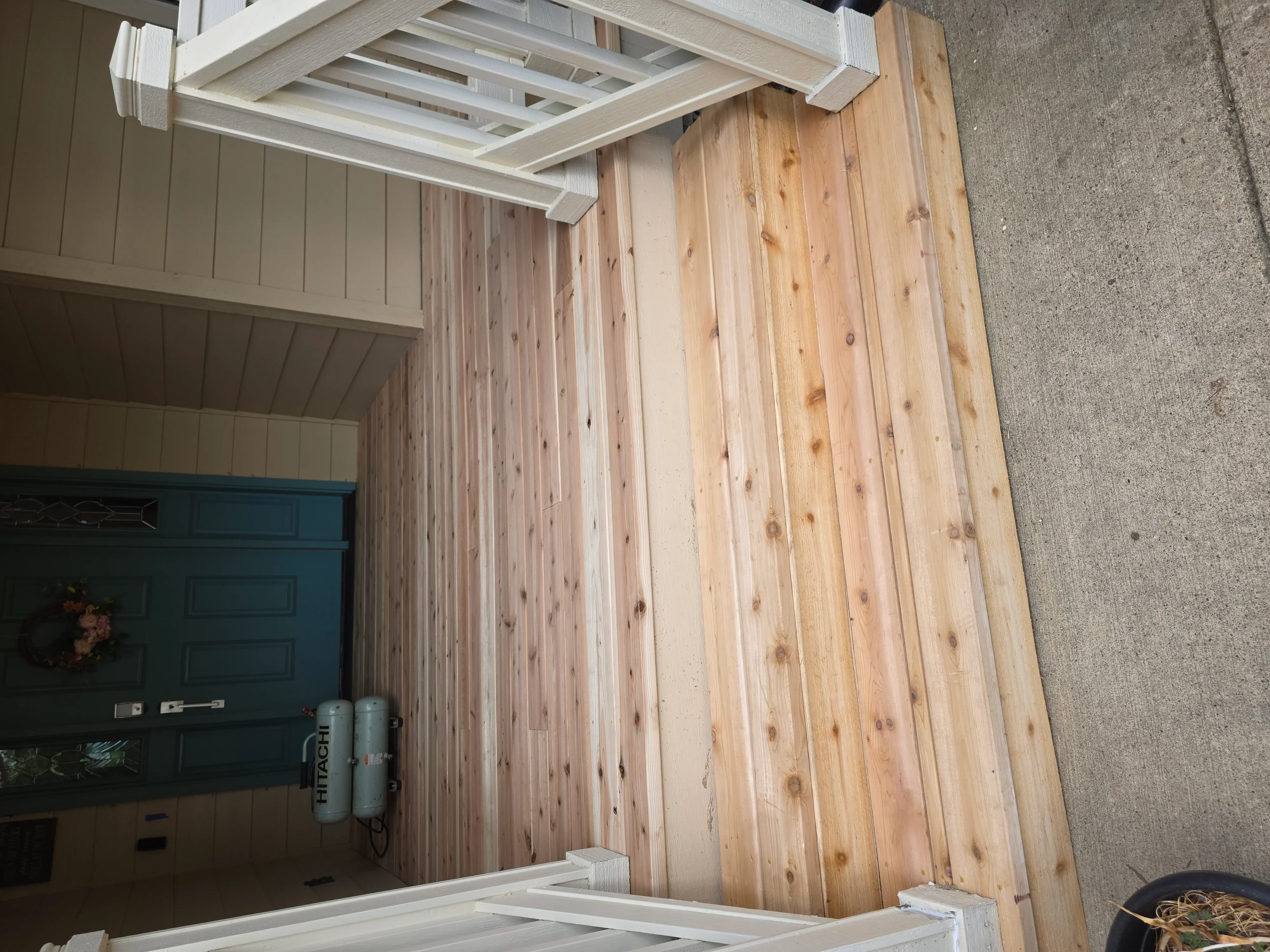 Vertical pine wood studs and white painted soffit framing in garage interior