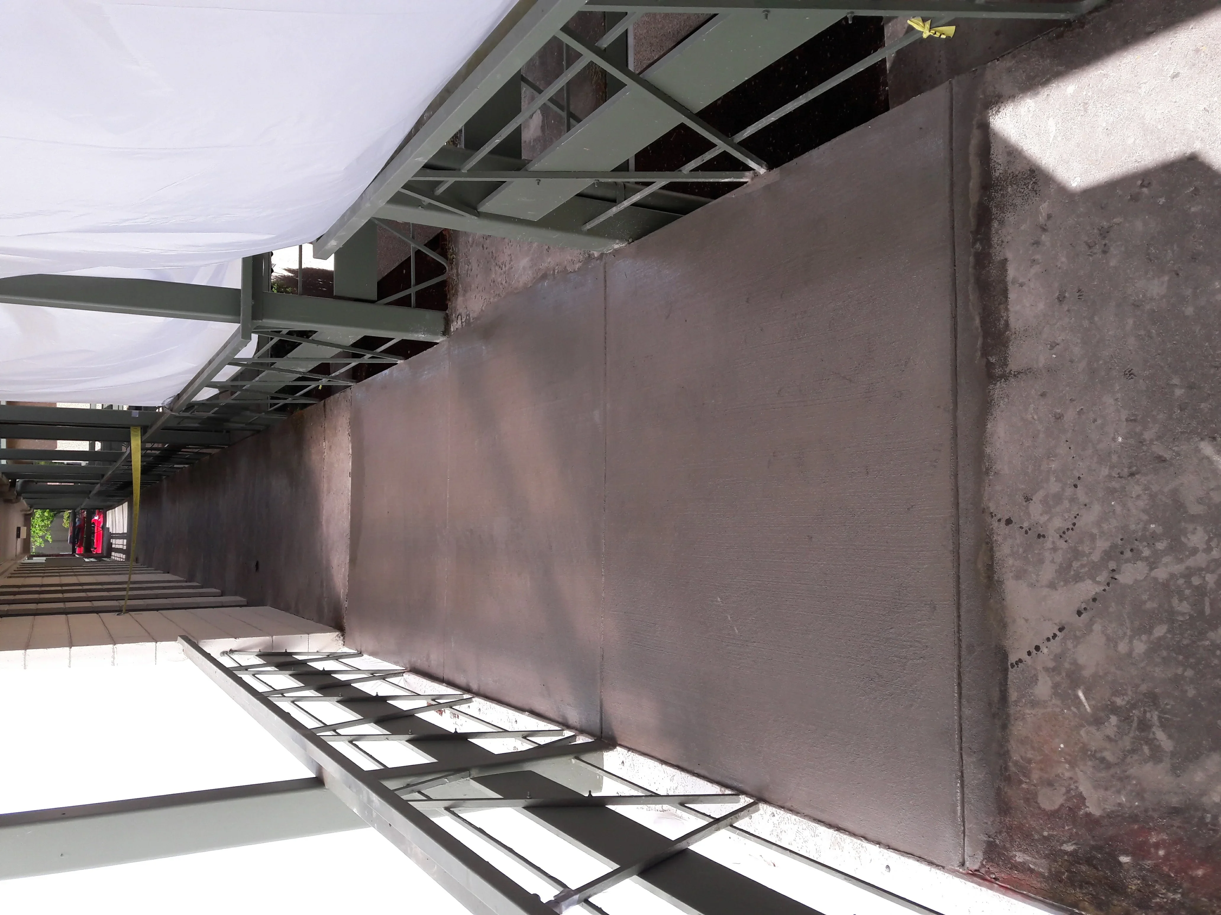 Steel stud framing with drywall installation in commercial interior space with metal track systems