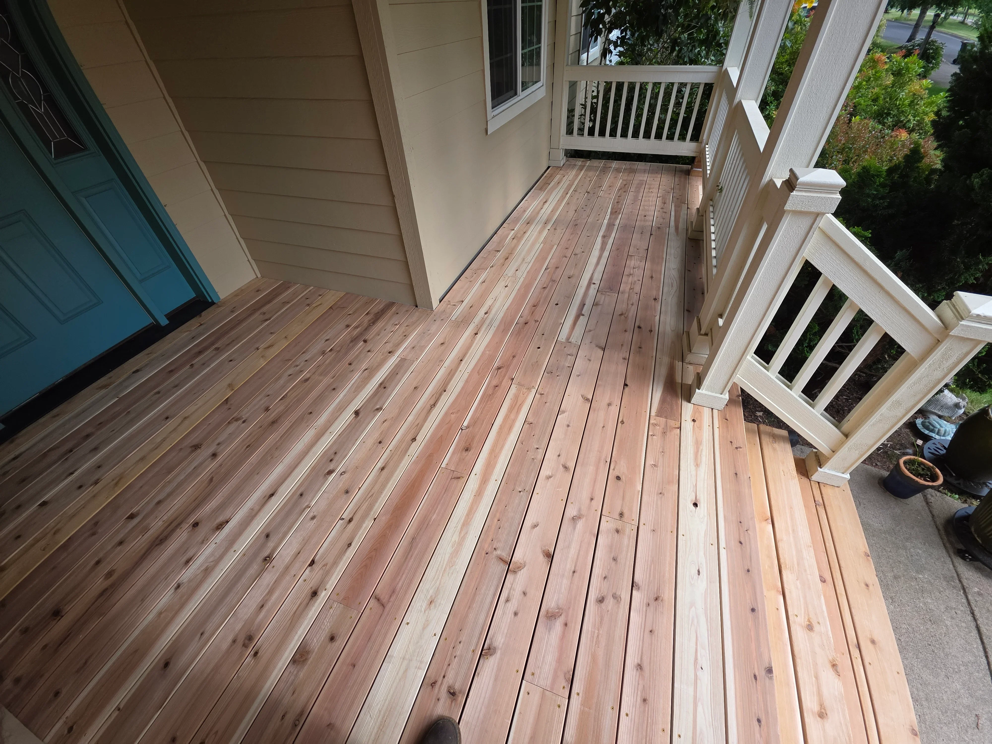 Composite deck with linear board pattern, white railings, and multi-level design