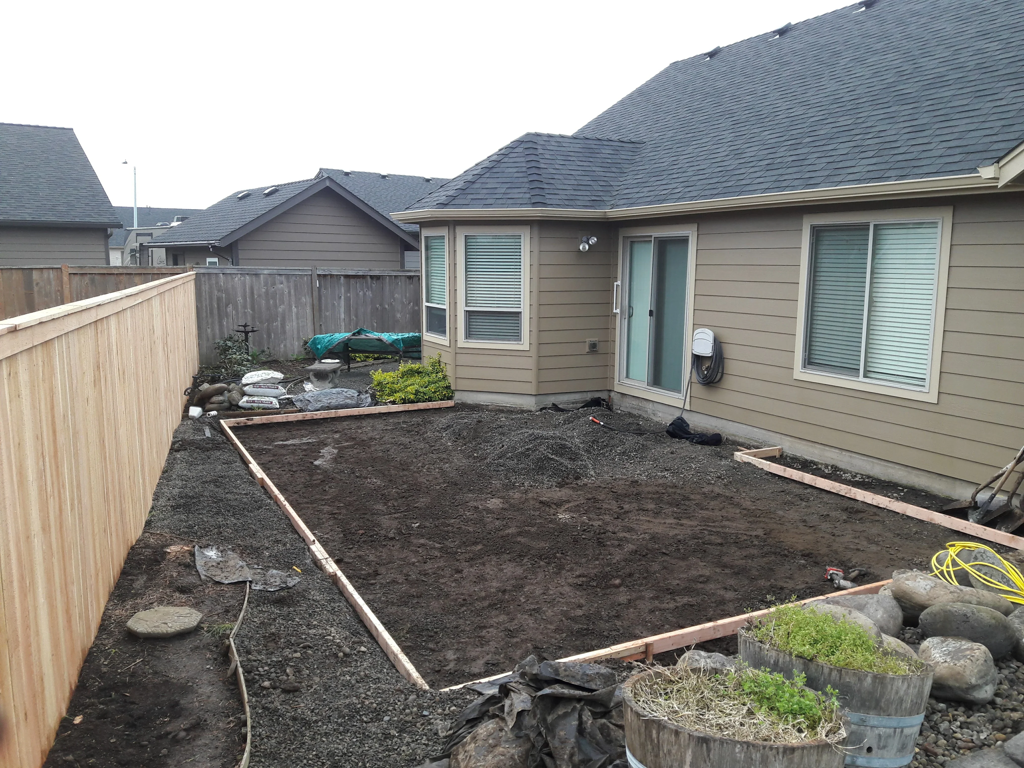 Backyard excavation with timber edging, gravel base, and landscape preparation