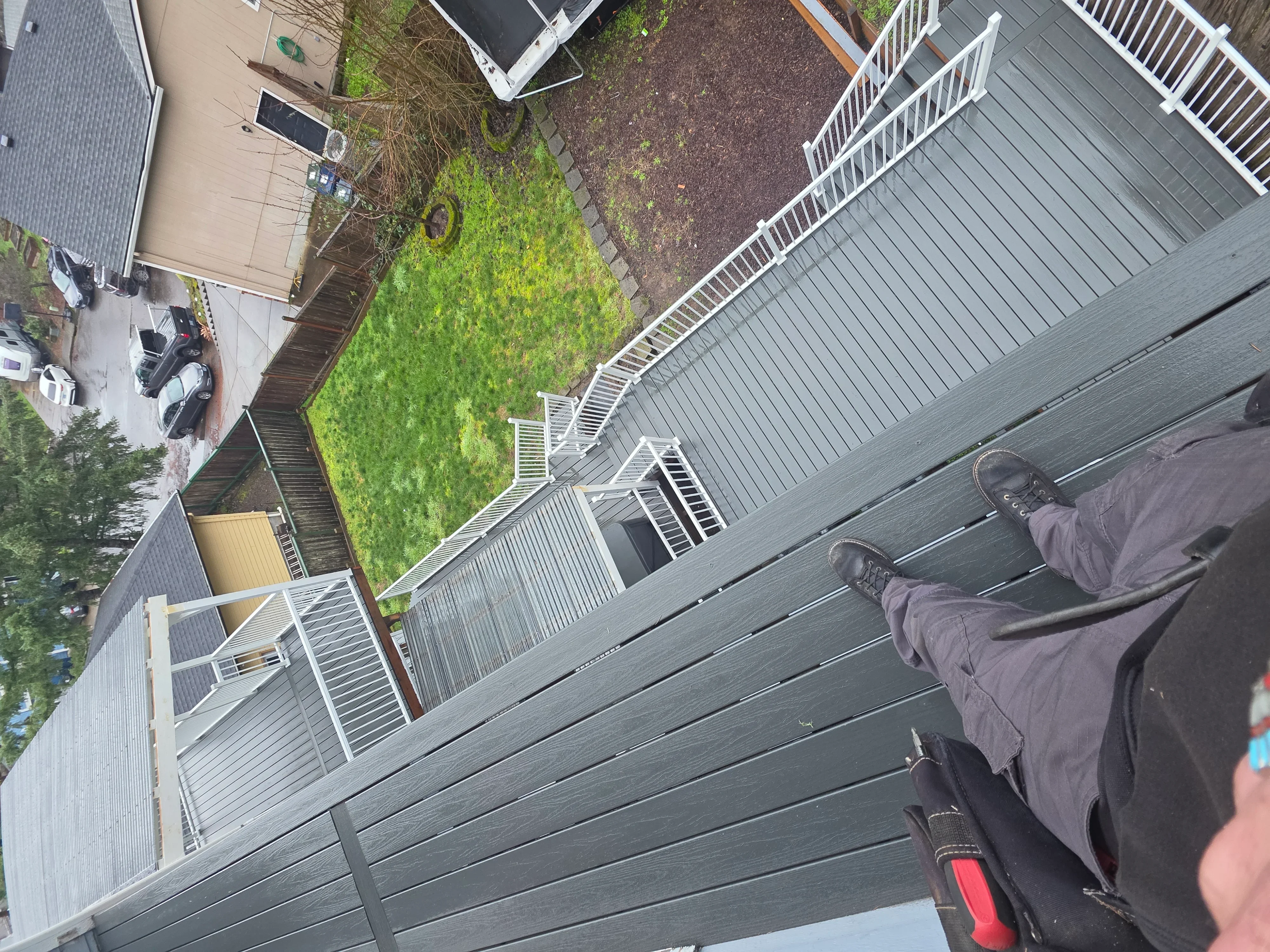 Gray composite deck with white railings, stairs, and multiple landing sections